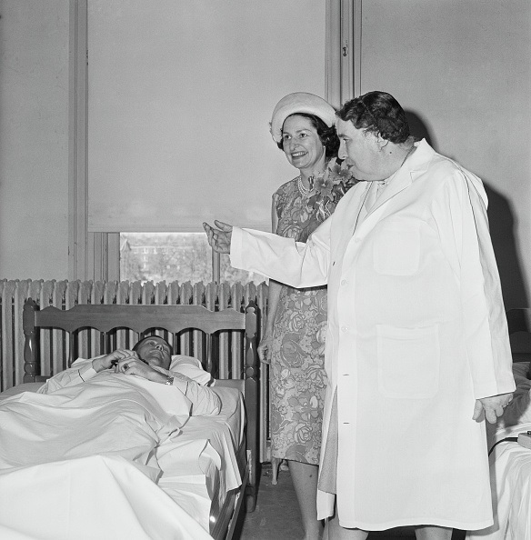 "Lady Bird" Johnson visits Dr. Mack's bed-rest study lab at TWU-Denton. They look at a man in a bed.