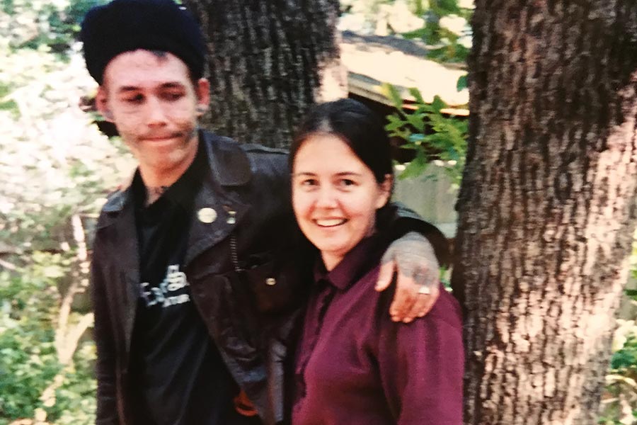 Aaron Fette with his arm around his mother, in front of two trees