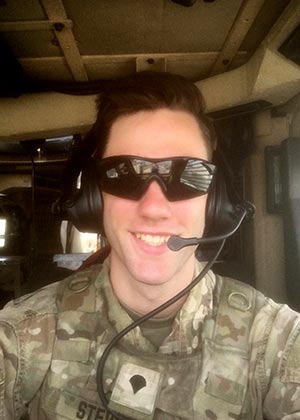Jeremiah Stevens wearing sunglasses and army uniform