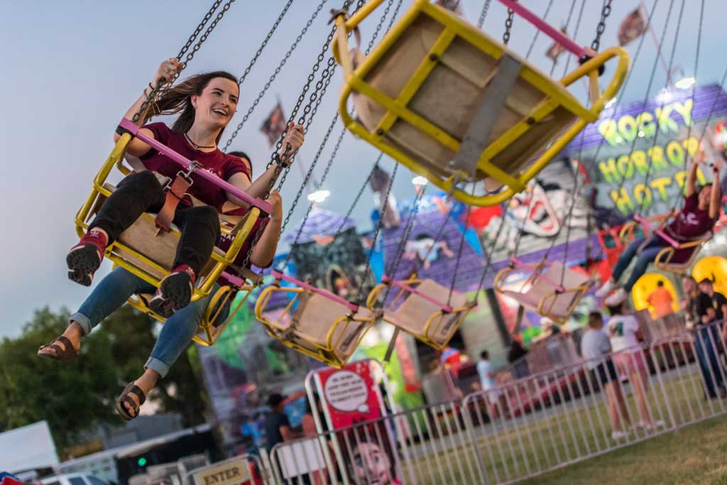 A TWU student on a carnival ride at the North Texas State Fair.