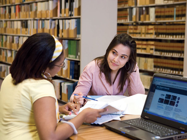 Two students studying in the TWU library