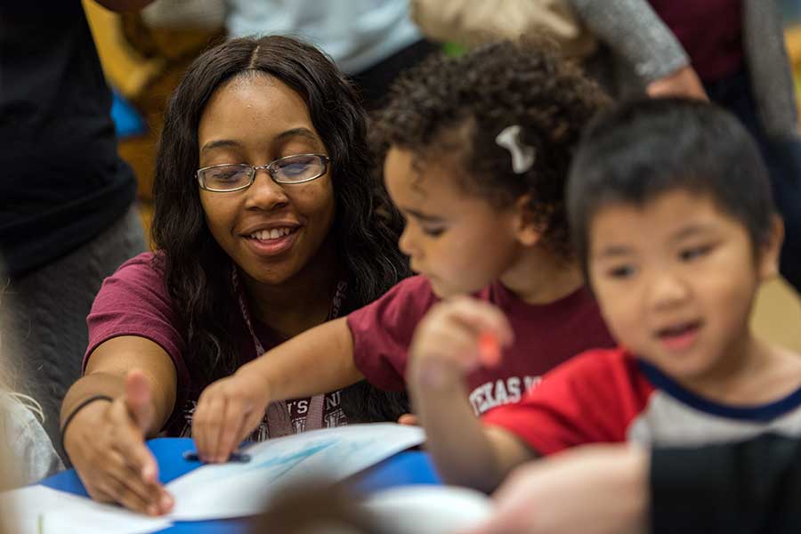 A TWU Early Childhood Education student reads with a child.