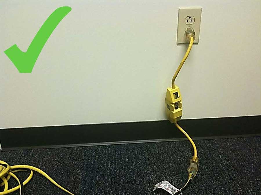 An extension cord plugged into a GFCI outlet