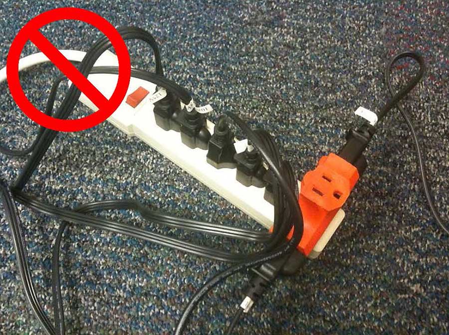 A power strip plugged into a multi-outlet adapter