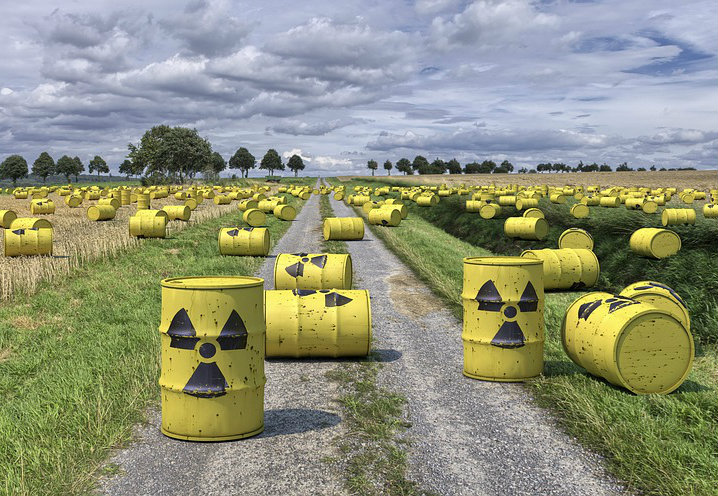 Radiation waste barrels on a road and in the pasture.
