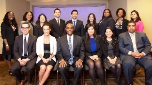 A group photo with fifteen people dressed professionally.