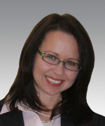 A woman with long brown hair smiling.