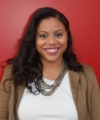 A photo of a smiling woman with long brown hair.