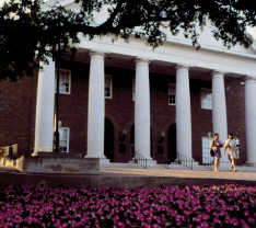 A photo of the Texas Woman's University library with two women walking.