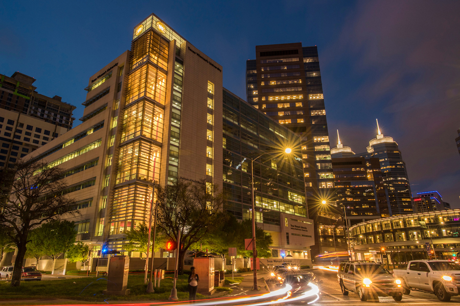 The TWU Institute of Health Sciences - Houston Center, showing city and car lights at night.	