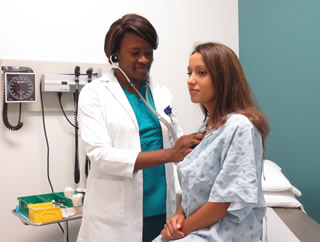 Nurse checking a patient with a stethoscope
