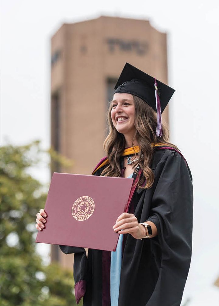 TWU student posing for graduation photo and smiling