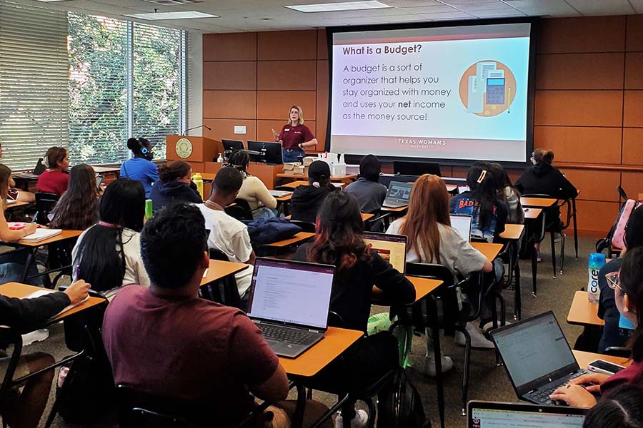 A Maroon Money Mentor gives a presentation on budgeting to a classroom of students