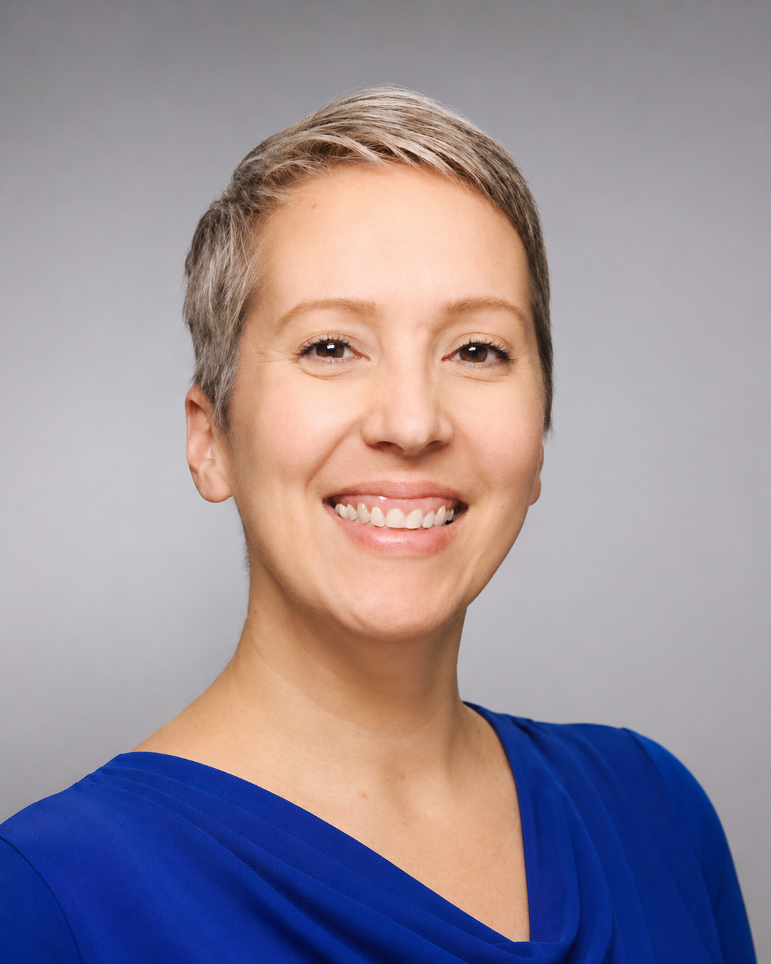 Professional headshot of Tabatha Rodriguez Fedorisko wearing business attire, facing the camera with a neutral background