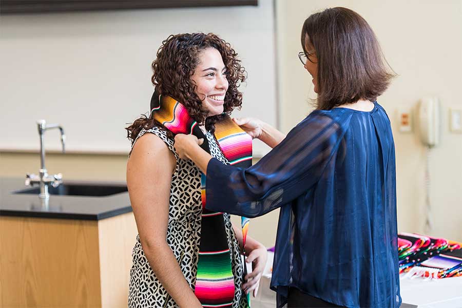 A TWU student has a sarape stole draped over her shoulders on TWU's Denton campus.	