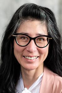 Headshot of Dr. Sara Ishii-Bear. Woman with dark hair and black frame glasses