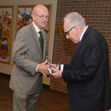 Dr. Neely presenting Dr. Woodcock a gift